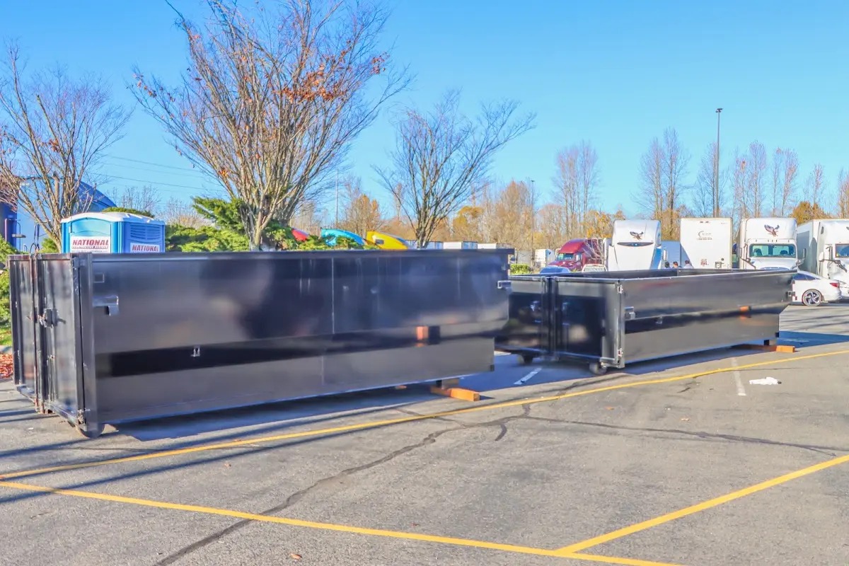 Professional dumpster rental service with roll-off container on residential driveway in Pilot Point